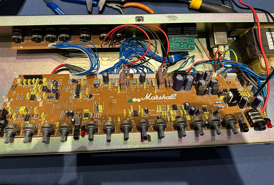 Open guitar amplifier being serviced